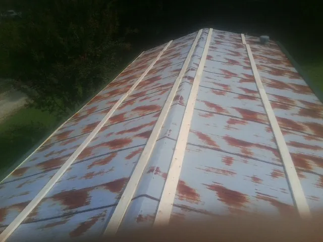 Rusted metal roof panels with new wood purlins before replacement — Storm Damage Roof Repair in Fillmore by Roofing Brothers